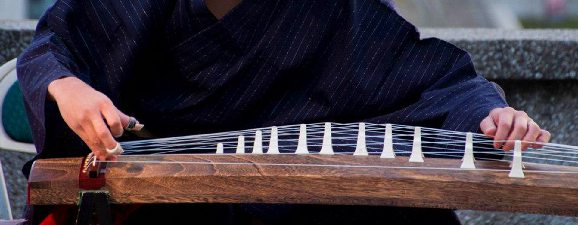 Person playing koto instrument