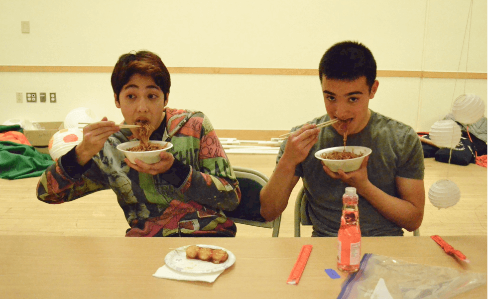 Two people eating yakisoba
